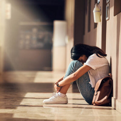 Troubled teen in school hallway
